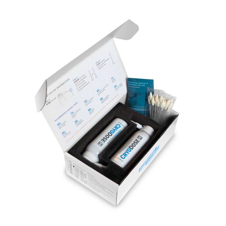 Open medical kit box containing CryoDose bottles, applicator sticks, and instructions.
