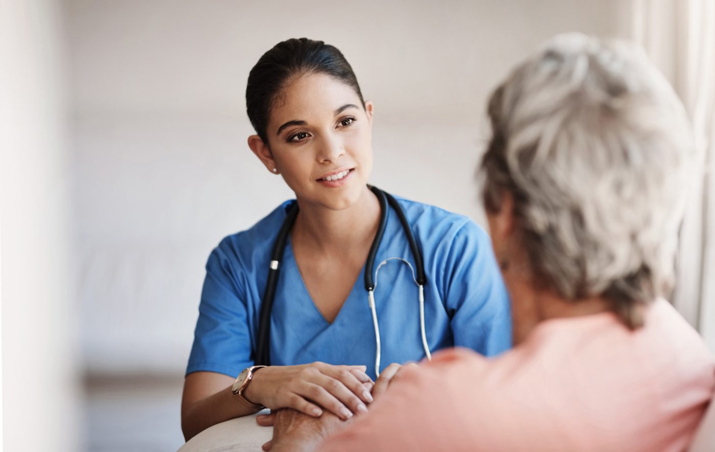Nurse talking with an elderly patient.