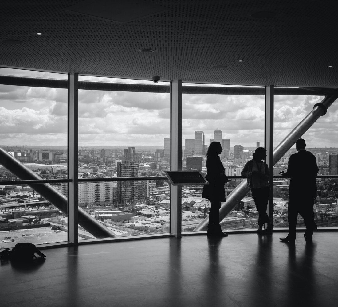 Picture of people meeting in front of building window
