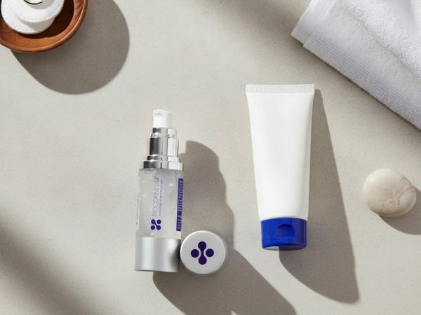 Mederma vs Biocorneum scar gel comparison with two scar treatment tubes in a clean editorial flat lay